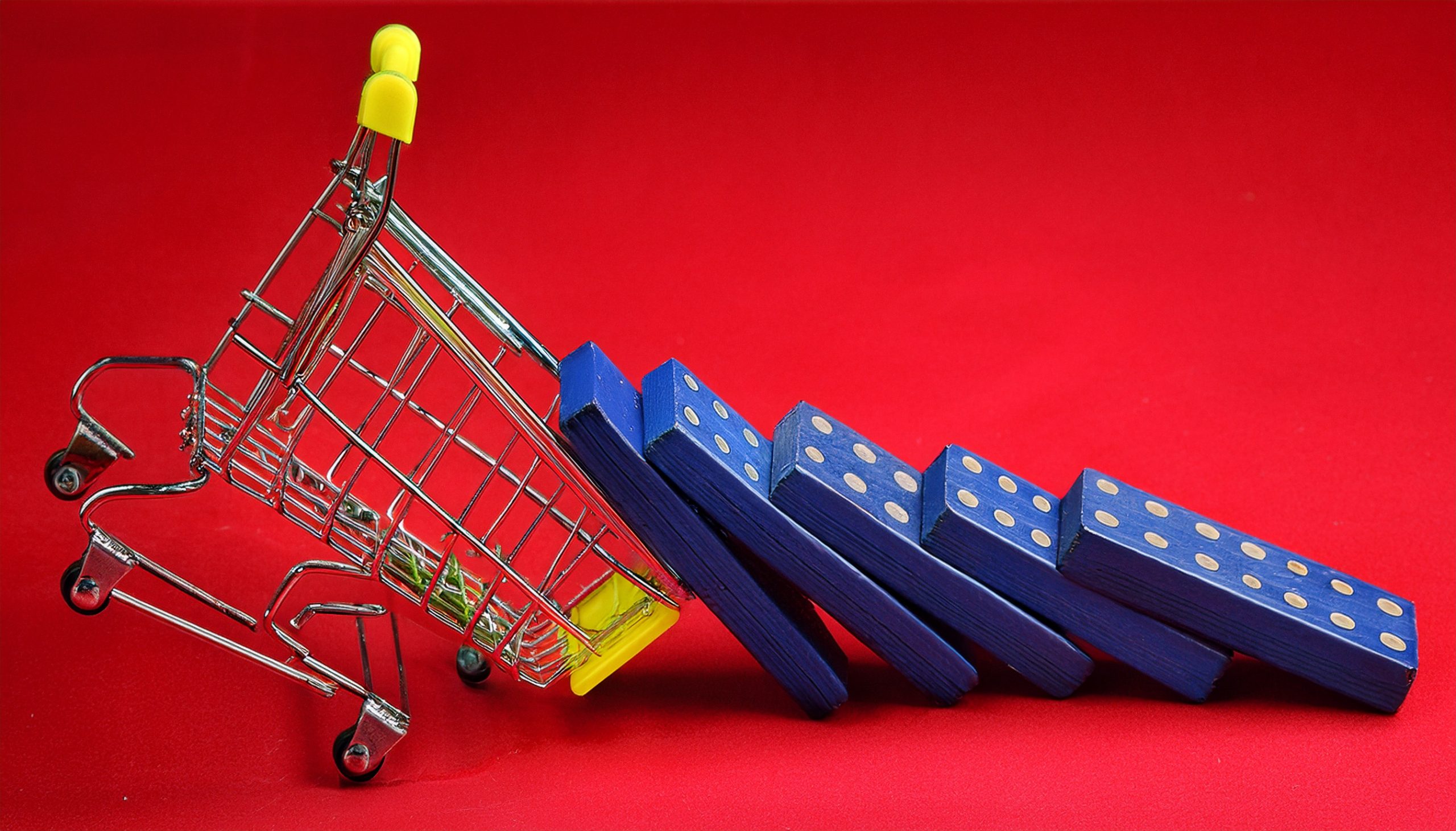 Dominos representing dirty data tipping over a shopping cart