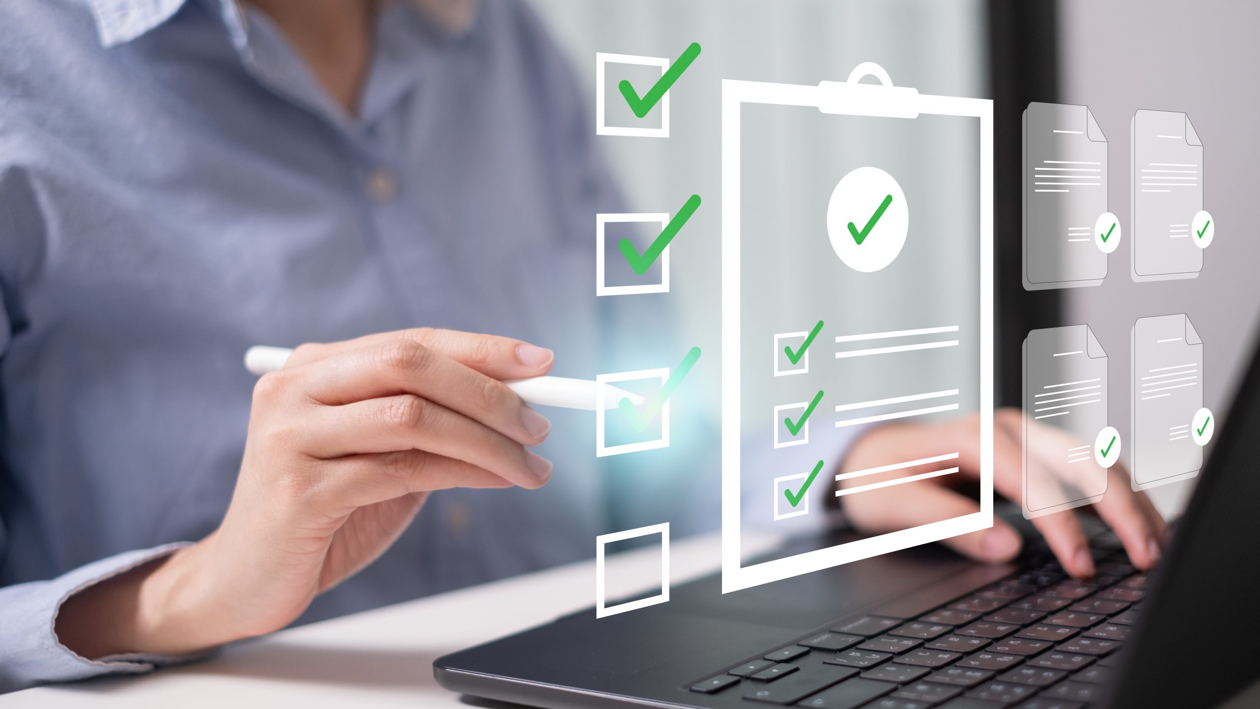 A person uses a stylus while a digital checklist graphic appears above a laptop screen.