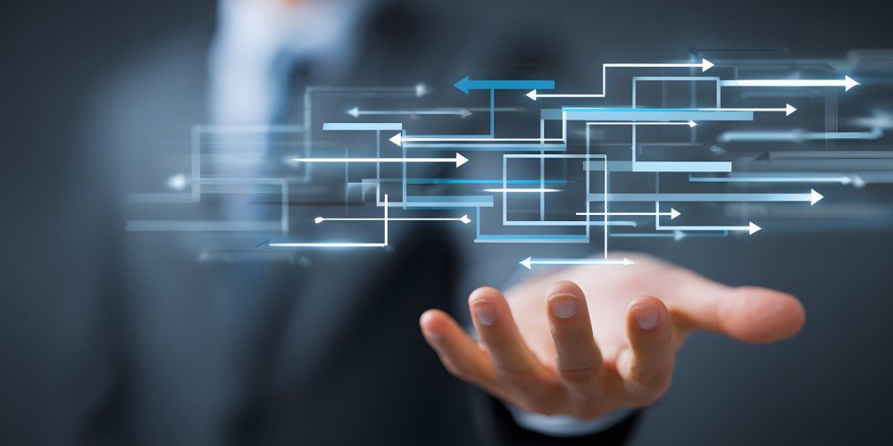 Hand extended beneath digital arrows and data pathways, symbolizing the structured delivery of provider data through APIs and FHIR-ready formats.